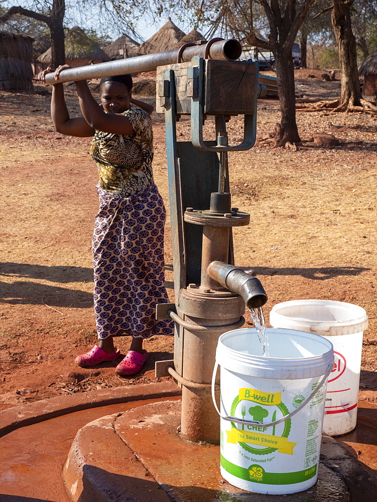 Pumping fresh water from a well in the fishing village of Musamba, on the shoreline of Lake Kariba, Zimbabwe, Africa