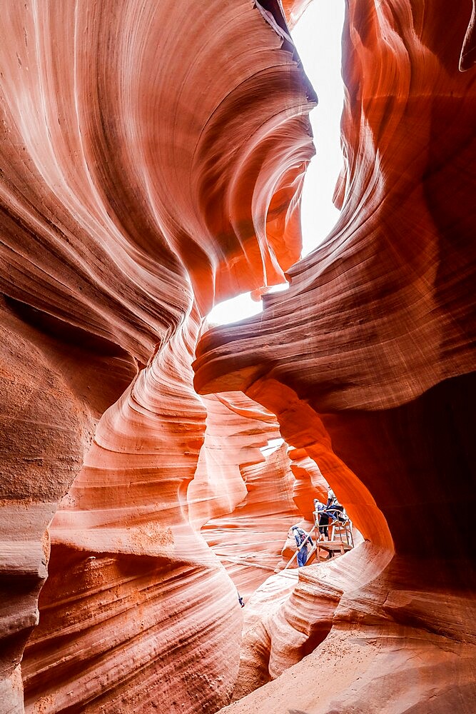 Tourists explore a slot canyon in Upper Antelope Canyon, Navajo Land, Arizona, United States of America, North America