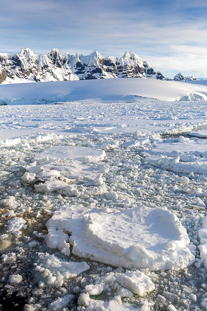 Snow-covered mountains and dense sea ice in Neumayer Channel, Palmer Archipelago, Antarctica, Polar Regions