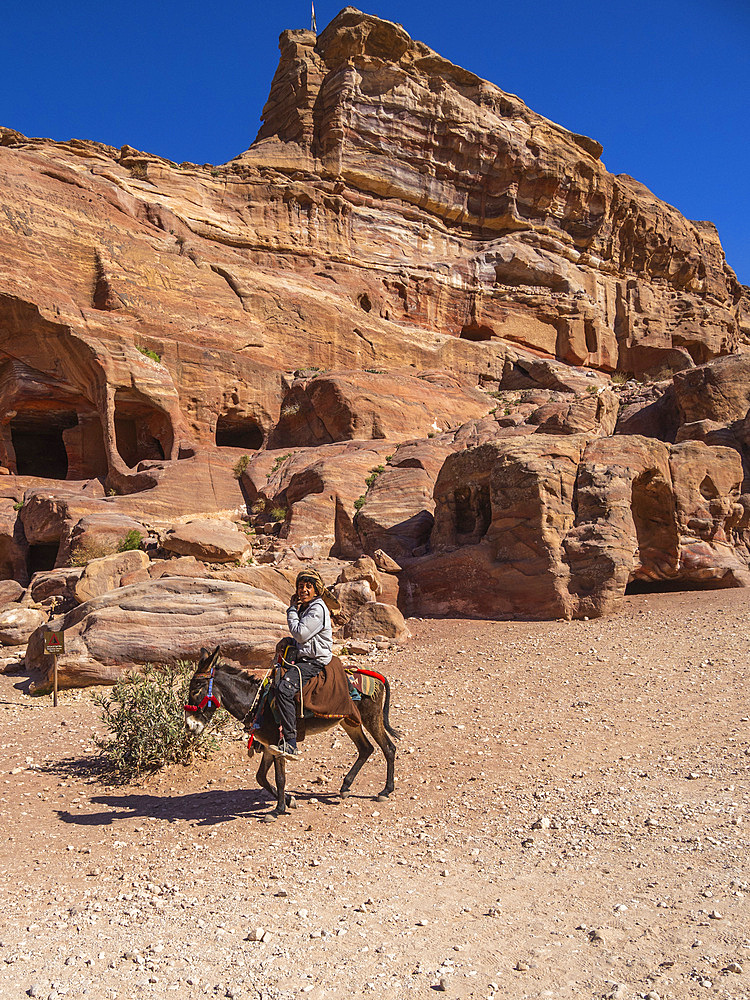 Donkey and rider, Petra Archaeological Park, UNESCO World Heritage Site, one of the New Seven Wonders of the World, Petra, Jordan, Middle East