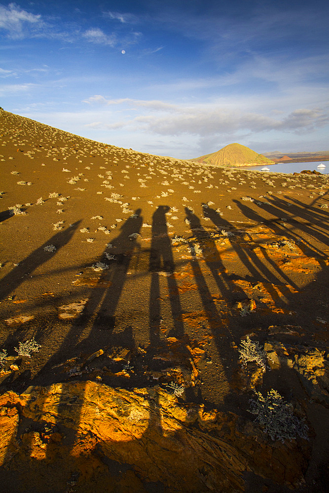 Human shadows on the lava formation and rock forms on the island of Bartolome in the Galapagos Islands, Ecuador.