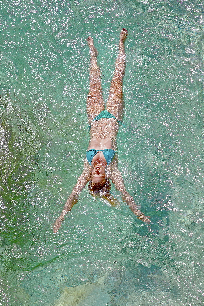 Young woman bathing in the river Soca, Alpe-Adria-Trail, Tolmin, Slovenia