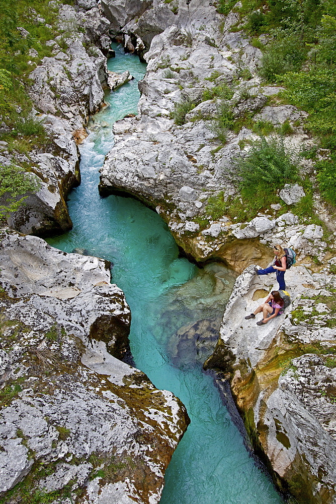 Two female hikers beside the river Soca, Alpe-Adria-Trail, Tolmin, Slovenia