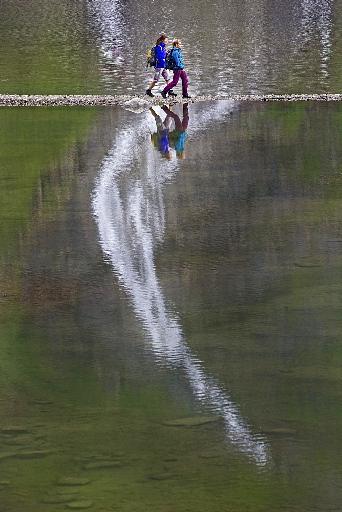 Two female hikers crossing Lake Faaker, Carinthia, Austria