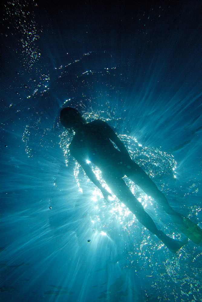 Underwater view of a woman snorkeling in blue water, Praia, Santiago, Cape Verde