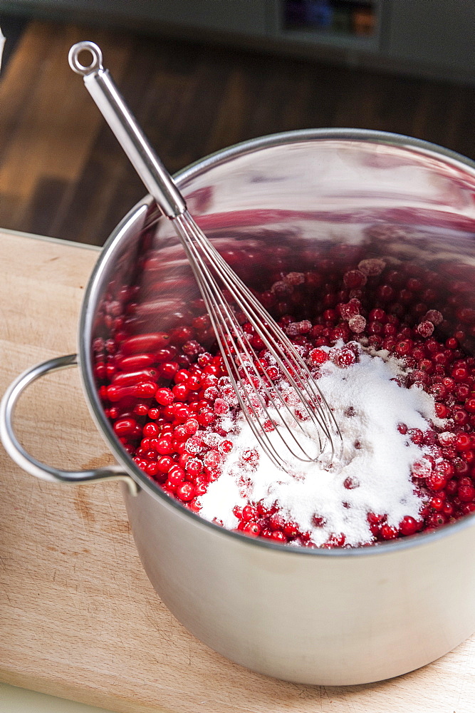 Sugar and currants in a cooking pot, making jam, Hamburg, Germany