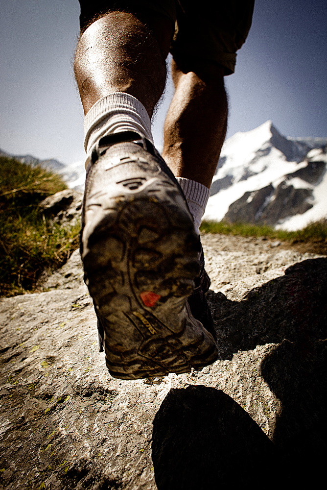 Hiker on mountain trail, on the way to Schreckhorn hut, Lower Grindelwald glacier, Bernese Oberland, Switzerland