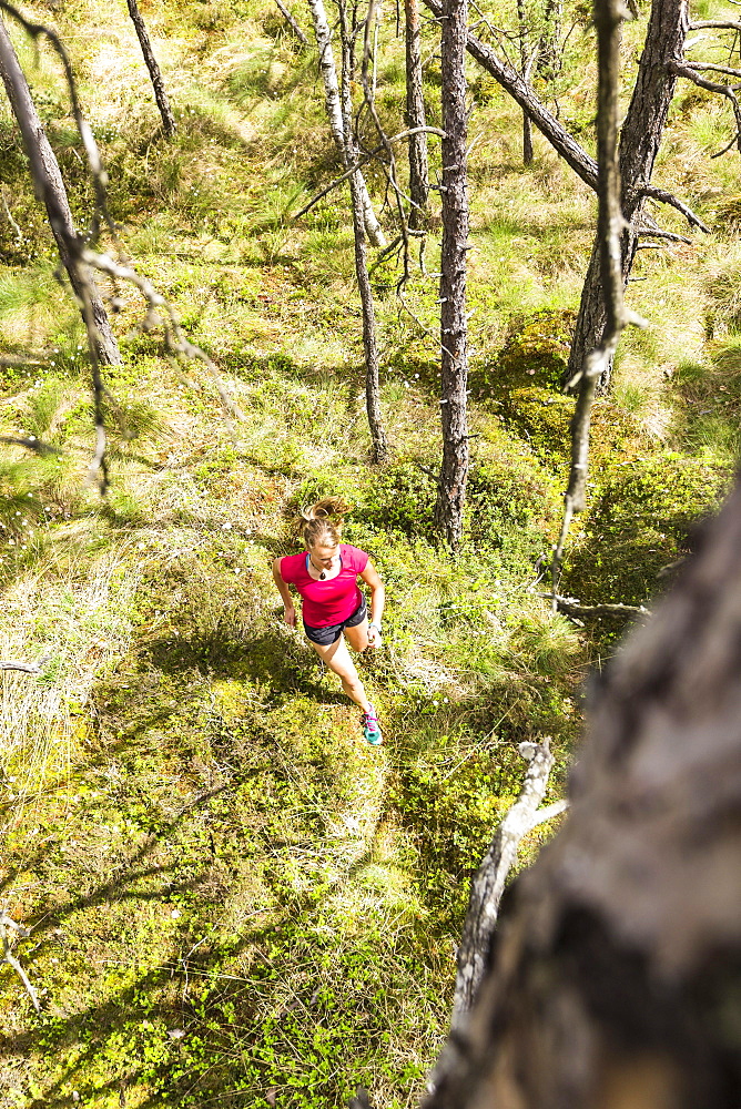 young woman running in a moorland forest, Berg at Lake Starnberg, Upper Bavaria, Germany