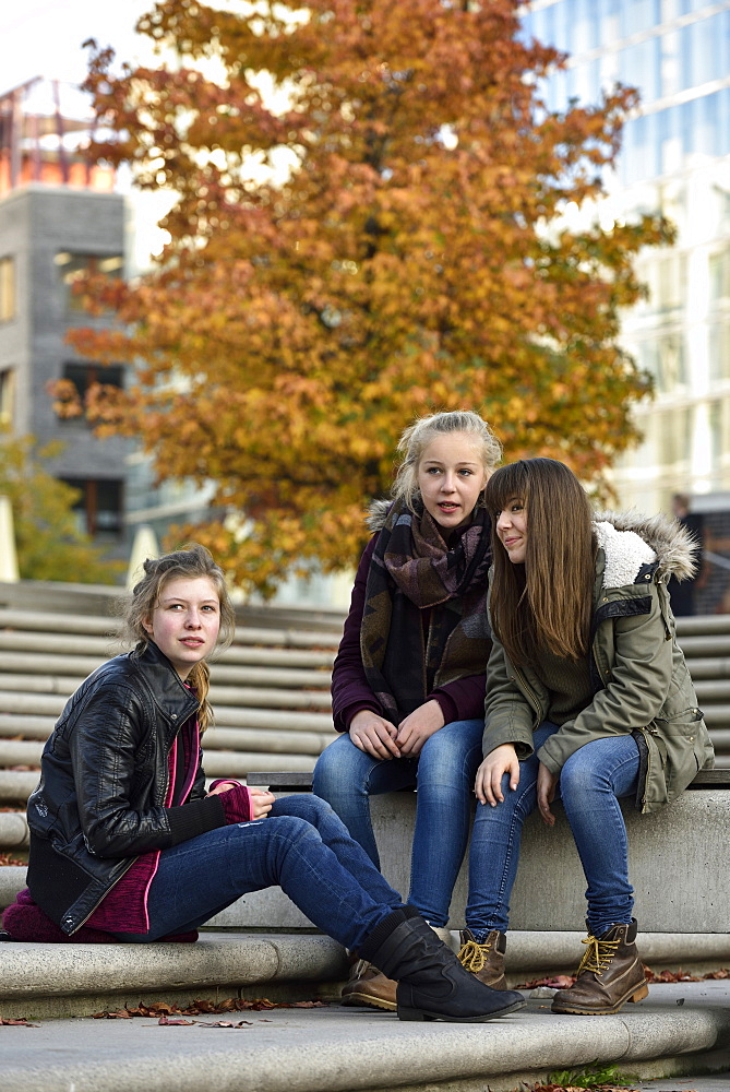 3 girls chatting outside in Hafencity, Hamburg, Germany, Europe