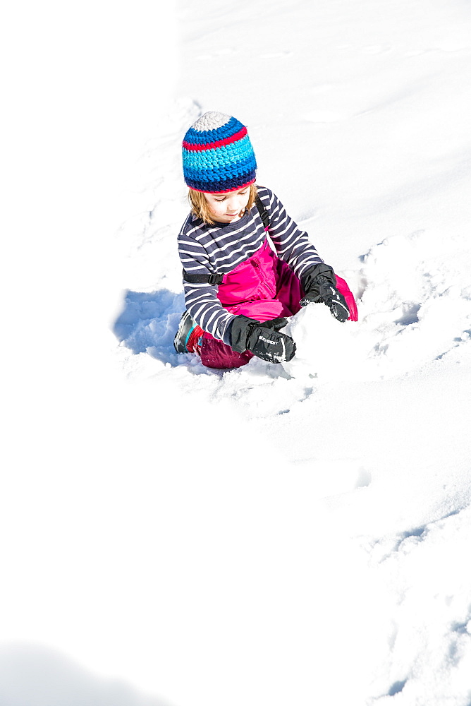 boy building a snowman in winter, Pfronten, Allgaeu, Bavaria, Germany