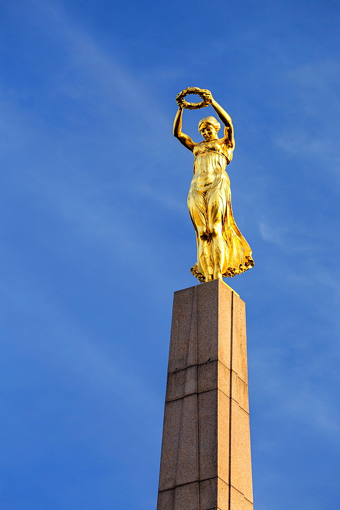 Close-up of gold statue on top of the Monument of Remembrance against blue sky, Luxembourg City, Luxembourg