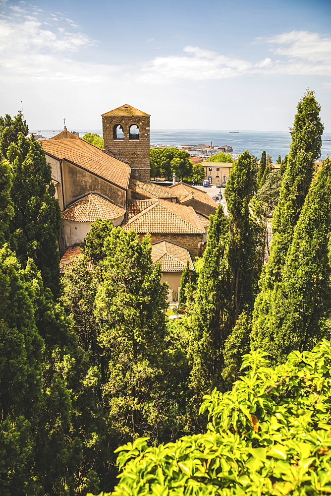 Terracotta tiled roof of a building and a view of the Adriatic Sea, Trieste, Friuli Venezia Giulia, Italy