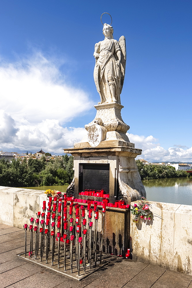 Statue of Archangel San Rafael, circa 1651, on the Puente Romano, Roman Bridge over the the Guadalquivir river, Cordoba, Andalucia, Spain