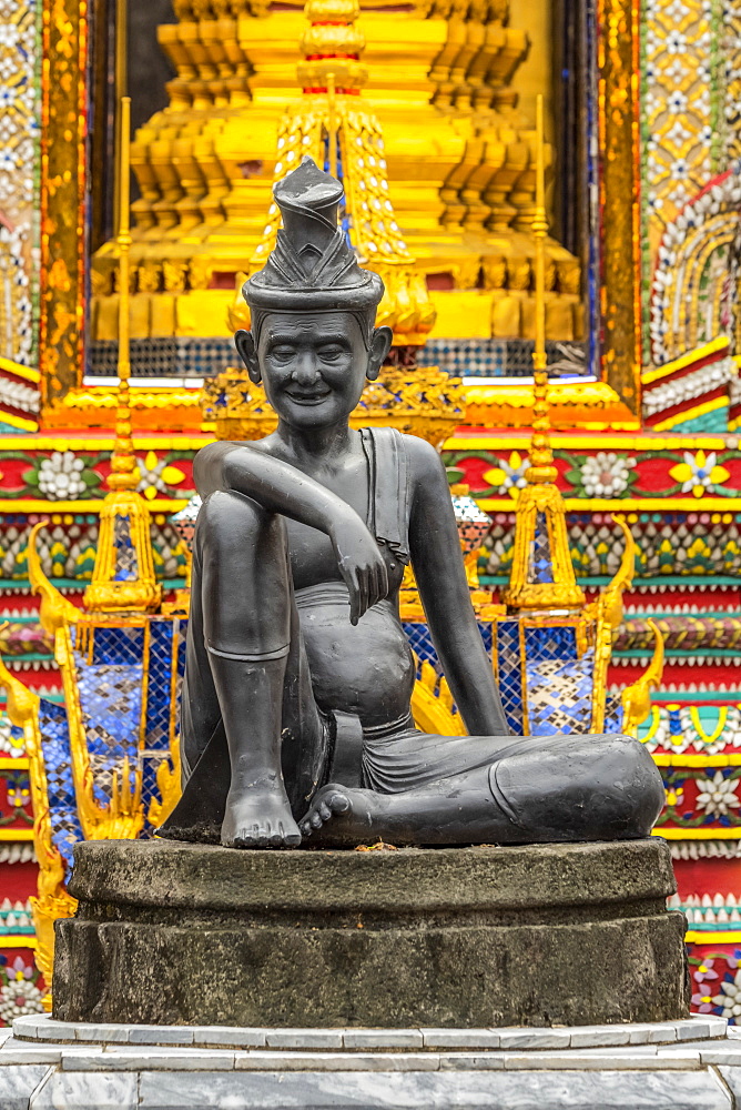 Bronze statue of seated man in hat, Bangkok, Thailand