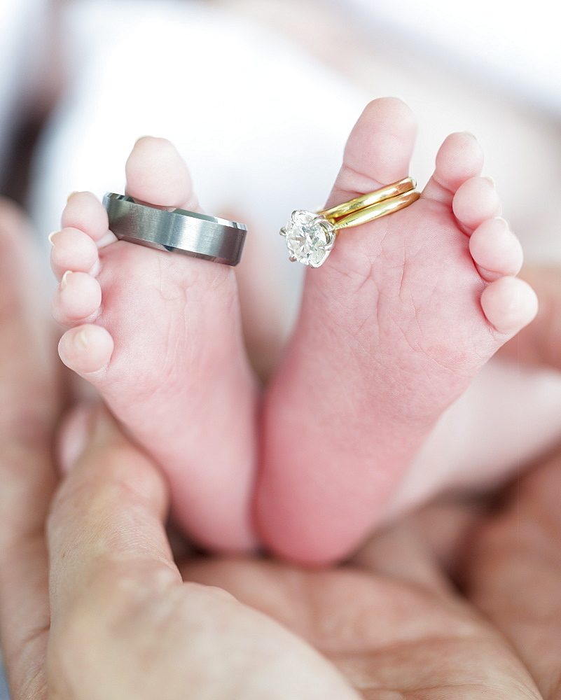 Wedding rings on a newborn babies toes, Surrey, British Columbia, Canada