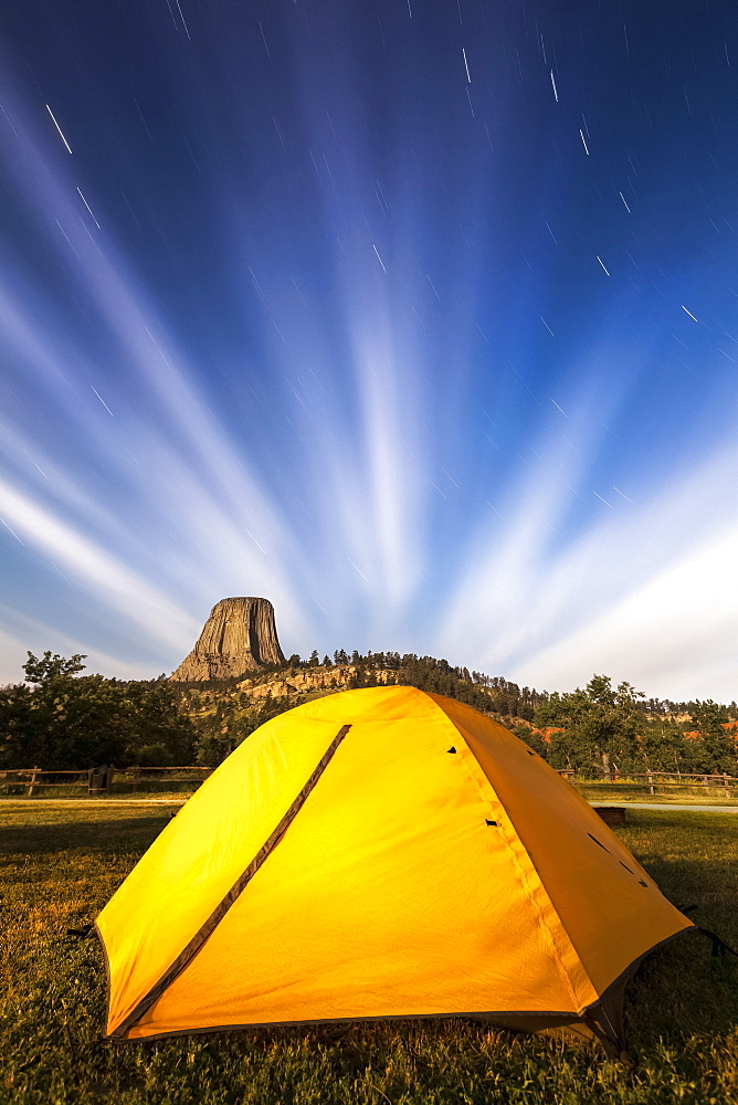 Bright yellow tent and star trails, Devils Tower National Monument, Wyoming, United States of America