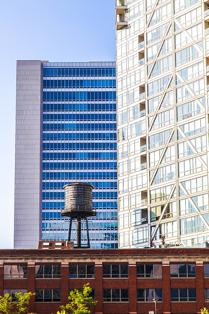 Buildings in downtown Chicago with a water reservoir on the rooftop of a residential building, showing the contrast of old and new buildings, Chicago, Illinois, United States of America