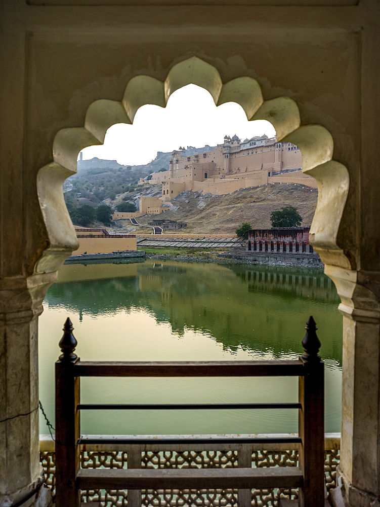 Maota Lake in front of Amer Fort viewed through a scalloped archway, Jaipur, Rajasthan, India