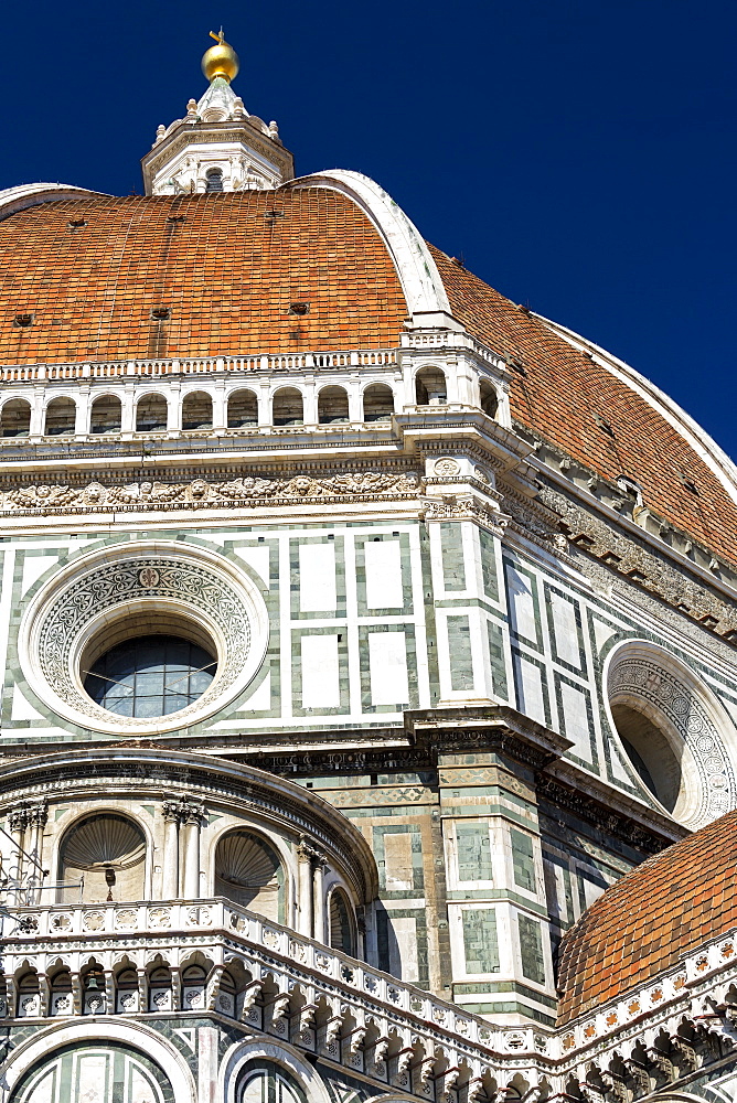 Close-up of Brunelleschi's Dome of Florence Cathedral decorative details of facade and blue sky, Florence, Tuscany, Italy