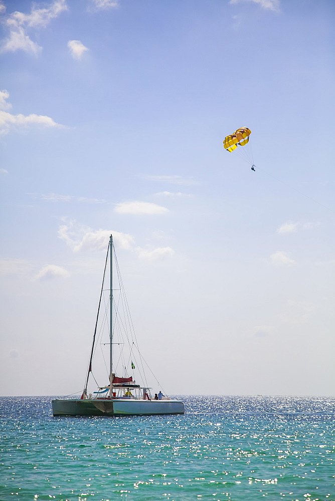 Large catamaran and parasailer on open tropical water, Negril, Jamaica