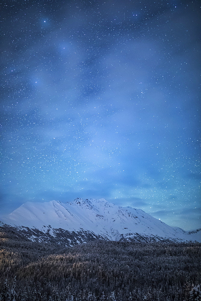 The faint glow of Aurora Borealis in the night sky illuminates the sparse cloud over Moose Pass, Kenai Peninsula, South-central Alaska, Moose Pass, Alaska, United States of America