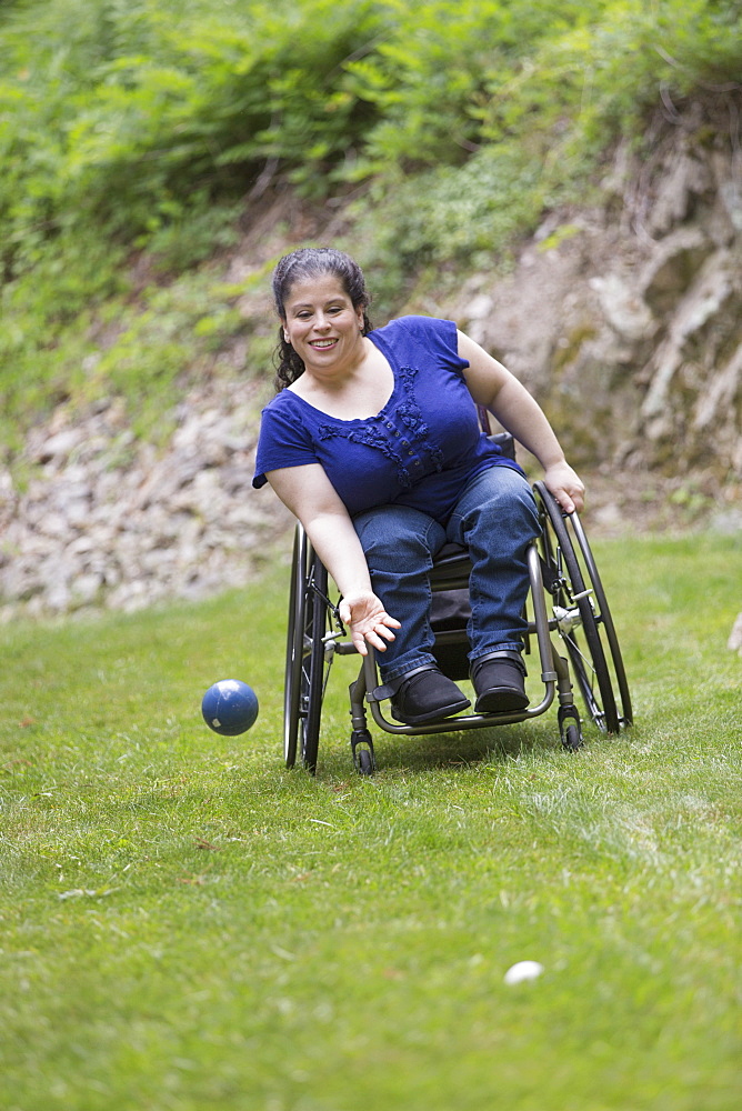 Woman with Spina Bifida in a wheelchair playing bocce ball