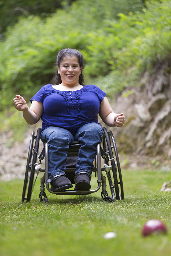 Woman with Spina Bifida in a wheelchair playing bocce ball