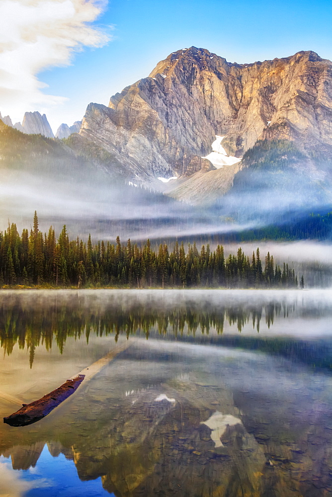 Tranquil lake with reflections in Elk Lakes Provincial Park; British Columbia, Canada