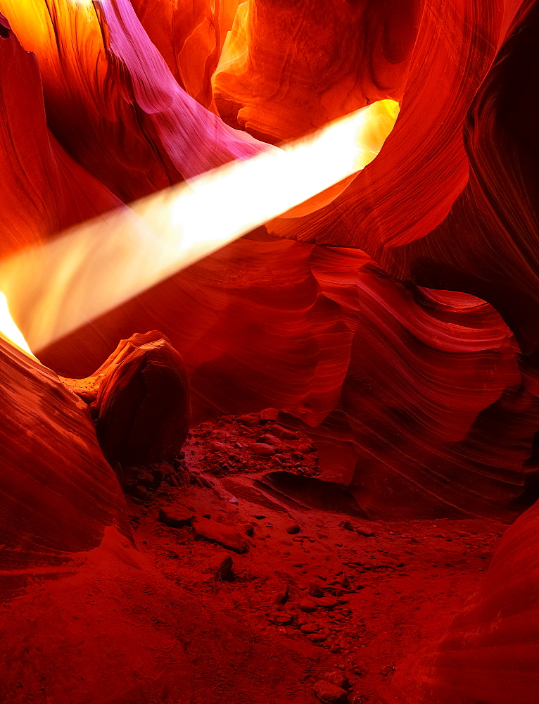 Lower Antelope Canyon with a beam of sunlight shining through a hole; Arizona, United States of America