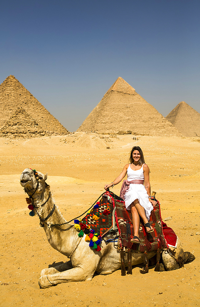 Female tourist on a camel, Giza Pyramid Complex, UNESCO World Heritage Site; Giza, Egypt