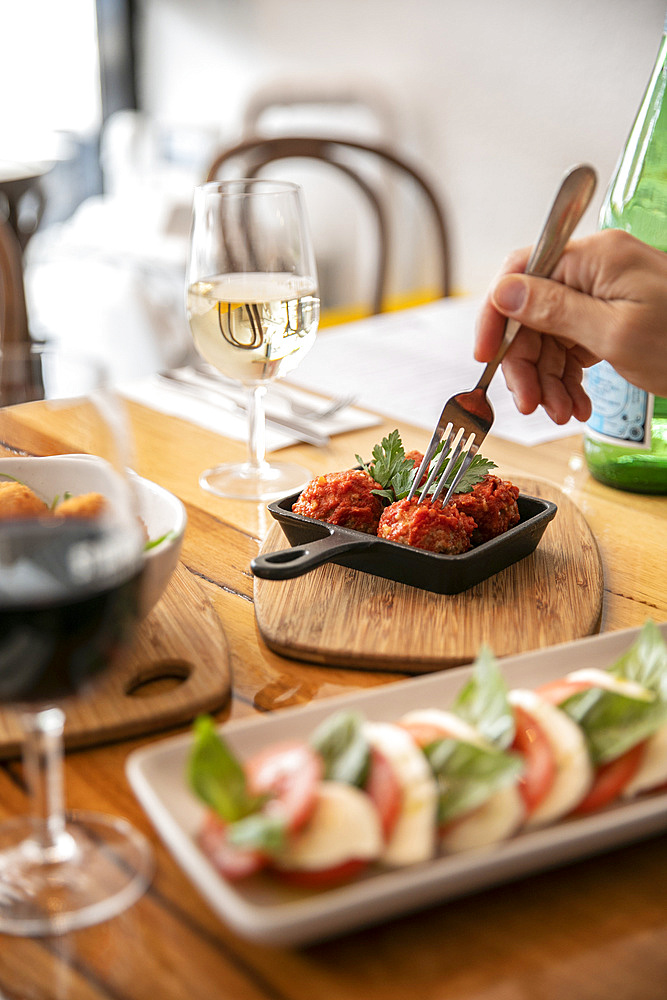 Eating meatballs in a restaurant; Melbourne, Victoria, Australia