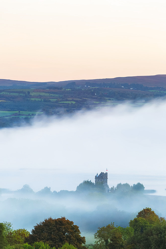 Castlebawn on the banks of Lough Derg surrounded in fog and mist at sunrise in autumn; Ogonnelloe, County Clare, Ireland