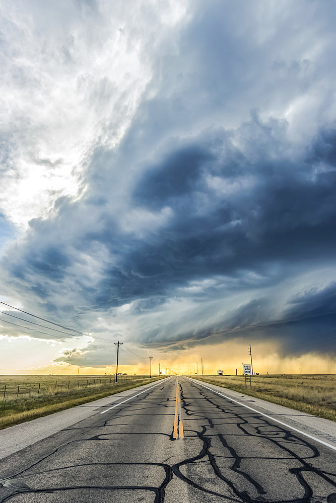 A low precipitation supercell crosses an empty highway near Roswell, New Mexico; Rowell, New Mexico, United States of America