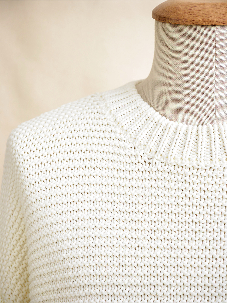 White knit sweater on mannequin; Studio