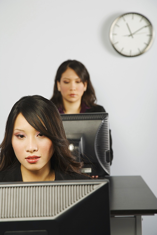 Two Women In Office Working At Computers