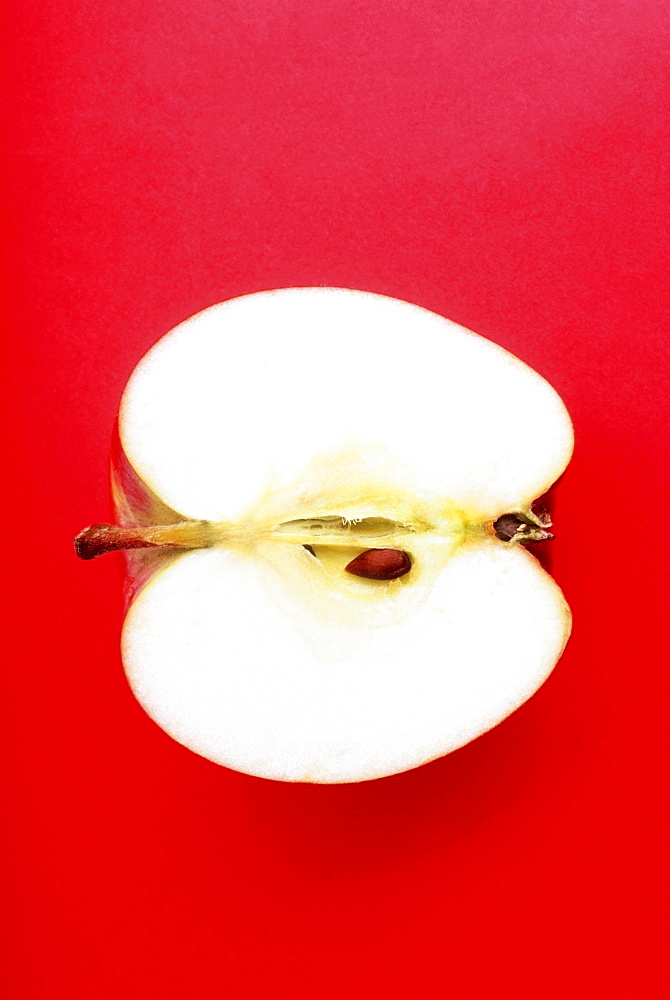 Half An Apple On Red Background