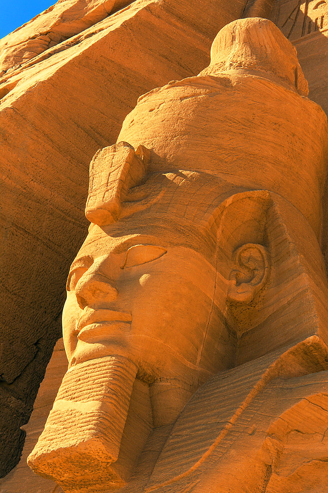 Close-up of the head of one of the Ramses II statues carved out of the mountainside at the front of the Great Sun Temple of Abu Simbel, Abu Simbel, Nubia, Egypt