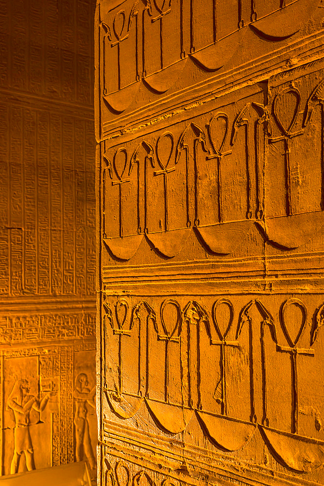 Close-up of the Hieroglyphic, bas-relief artwork on the walls inside the Temple of Horus in golden light, Edfu, Egypt, North Africa