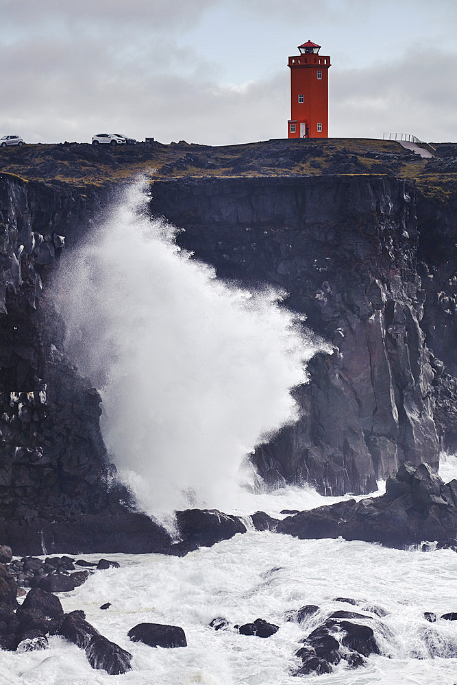 Surf on cliffs and red lighthouse at Skalasnagi, Snaefellsnes peninsula, west coast of Iceland, Iceland