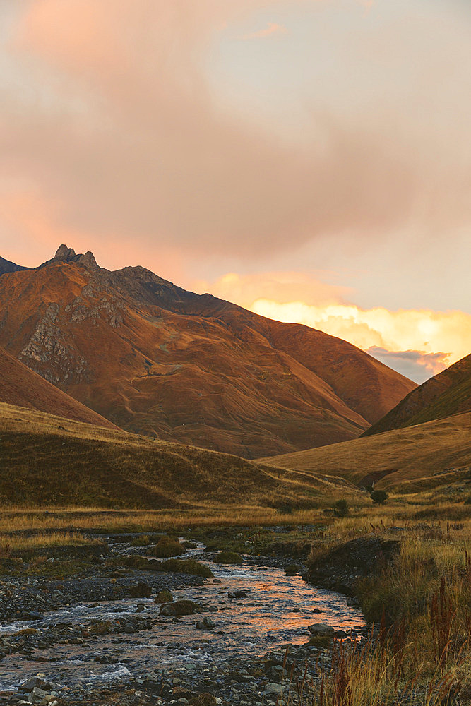 Kazbegi National Park during a tranquil sunset with a mountainous terrain, Georgia