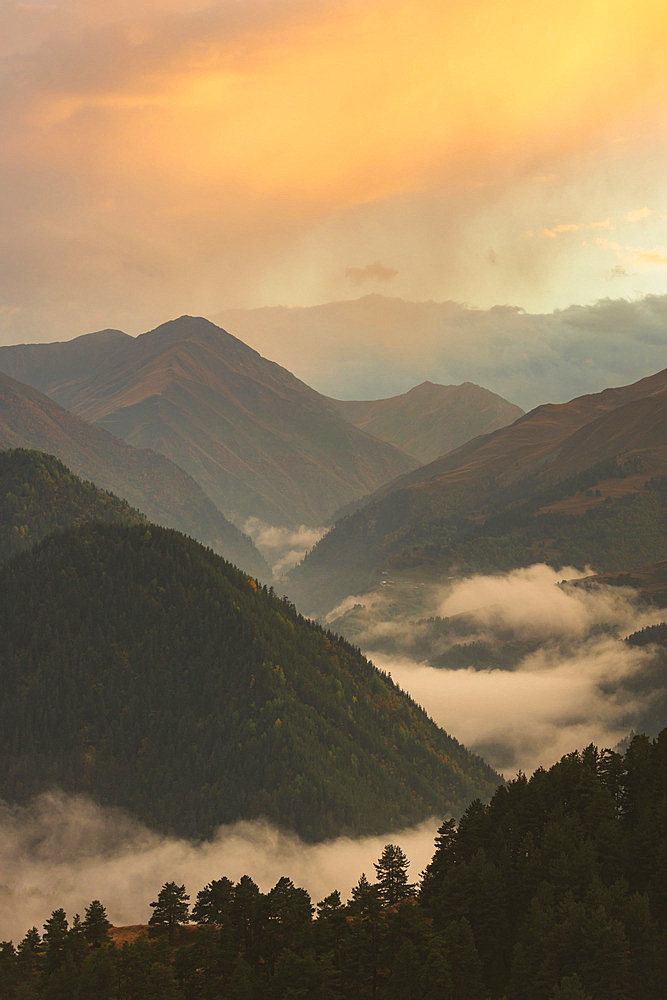 Tusheti National Park at sunset, with low clouds sitting in the mountain valleys, Omalo, Tusheti, Georgia