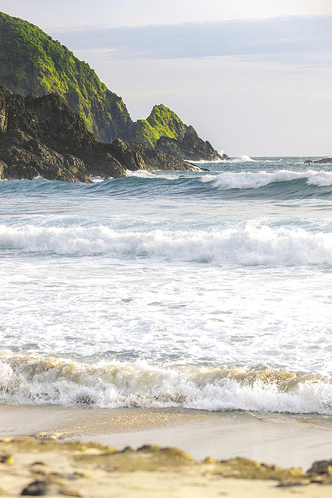 Waves rolling into shore along an Indonesian island at Telawas Beach, Mekar Sari, Praya Barat, Central Lombok Regency, West Nusa Tenggara, Indonesia