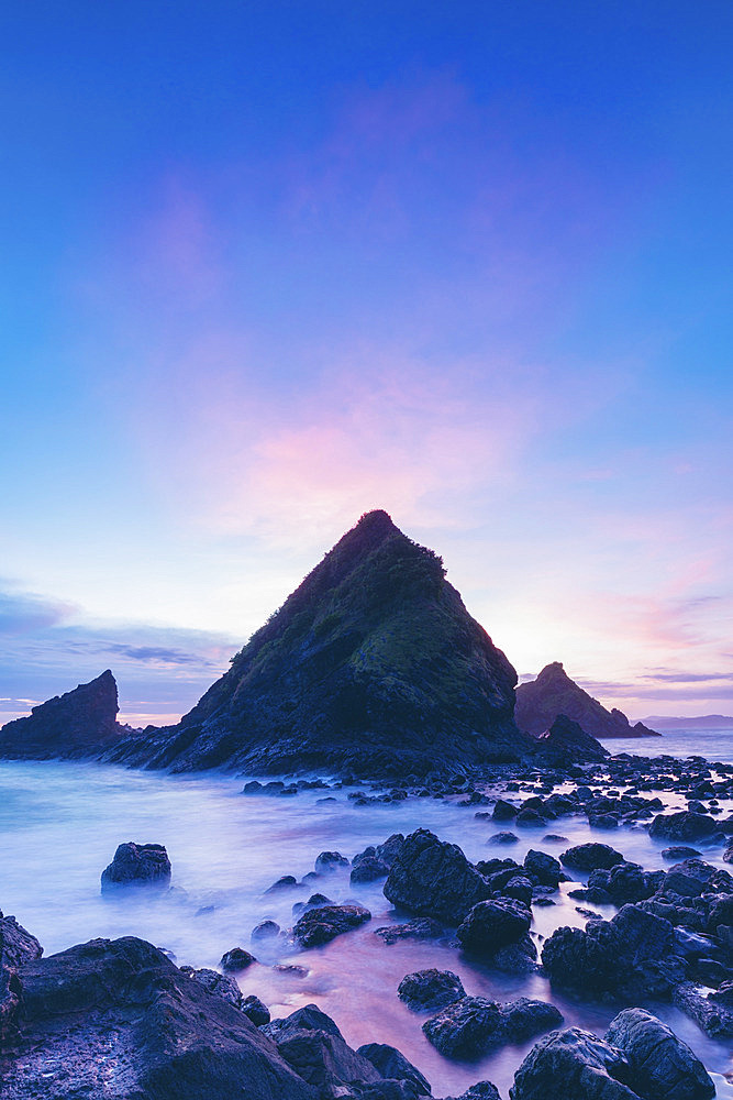 Blue hour along the rugged coast of an Indonesian island at Telawas Beach, Mekar Sari, Praya Barat, Central Lombok Regency, West Nusa Tenggara, Indonesia