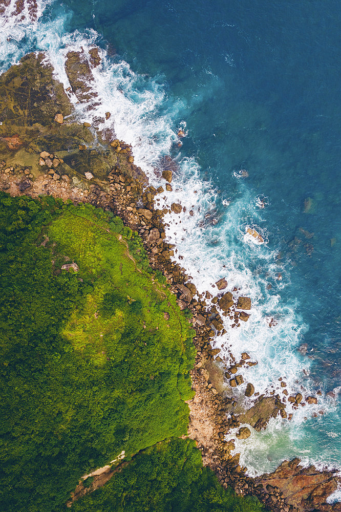 Aerial view of the rugged coastline and lush vegetation on Seger Beach, Kuta, Kecamatan Pujut, Kabupaten Lombok Tengah, Nusa Tenggara Barat, Indonesia