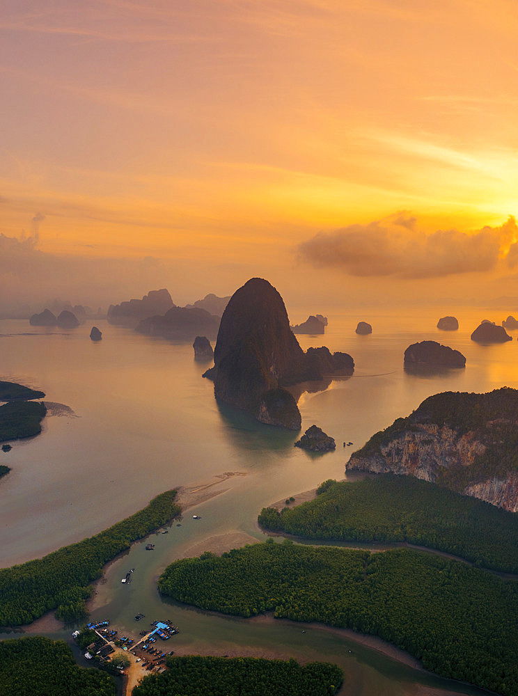 Karst rock formations and a dramatic sunrise in Ao Phang Nga National Park, with mist over the Southern Thailand landscape, Ao Phang Nga, Phang-nga, Thailand