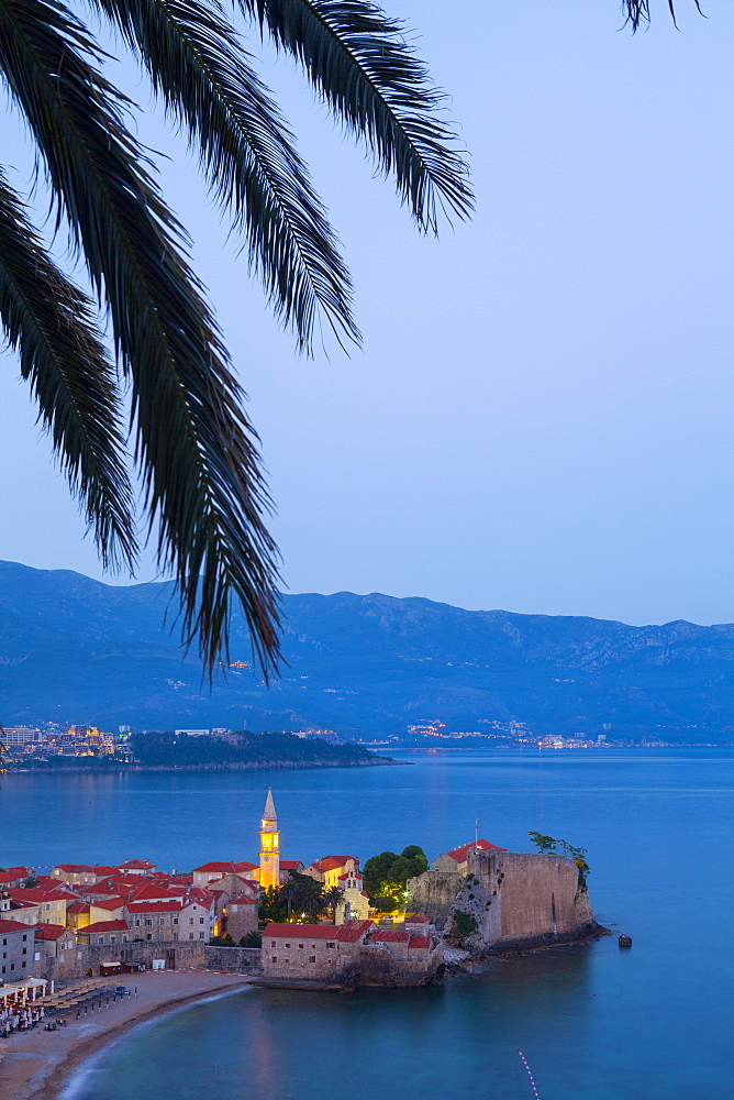 Elevated view over Budva's picturesque Stari Grad (Old Town) illuminated at dusk, Budva, Montenegro, Europe