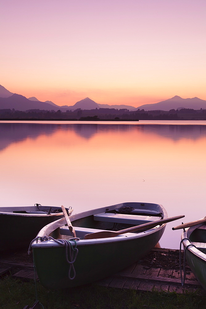 Rowing boats on Hopfensee Lake at sunset, near Fussen, Allgau, Allgau Alps, Bavaria, Germany, Europe 