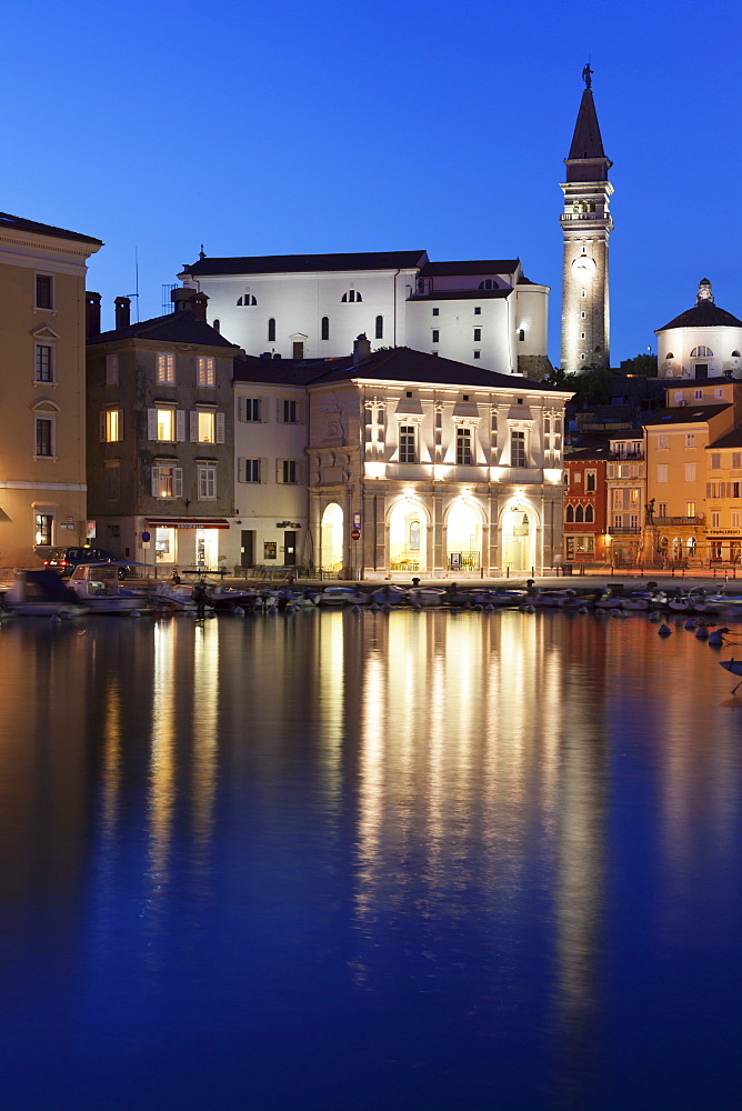 Waterfront buildings at the harbour and bell tower of Cathedral of St. George, Piran, Istria, Slovenia, Europe