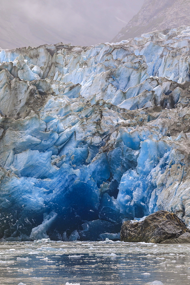 Blue ice face and floating ice, Sawyer Glacier and mountains, misty conditions, Stikine Icefield, Tracy Arm Fjord, Alaska, United States of America, North America