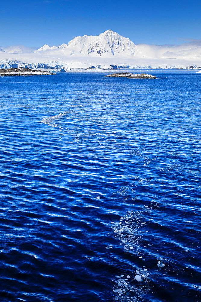 Misty Mount William under a blue sky, from the sea off Anvers Island, Antarctic Peninsula, Antarctica, Polar Regions